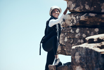 Black woman, climbing a rock mountain and adventure in nature for healthy exercise or sport...