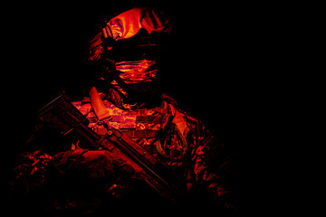 Armed infantry with hidden face standing during combat, counter terrorist night raid, protected perimeter control, state border patrolling and protecting