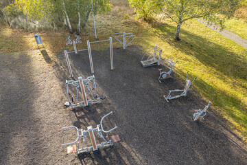 Aerial view on outdoor fitness equipment, European gym in a village, street workout