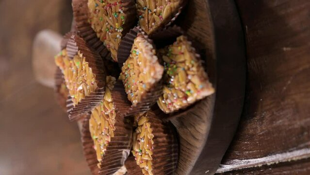 Desserts with almonds, peanuts and seeds in caramel. Traditional Sardinian sweet. Sweet squares. High quality 4k footage. Almond Gateau, sarda Food, for smartphones and social networks