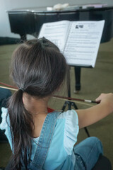 Student on violin lesson in the room.
