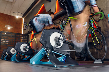 Man cycling gym machine equipment, motion blur