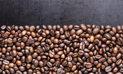 Coffee beans on dark background, close-up still life copy space for text