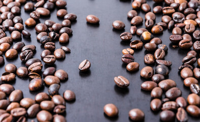 Loose coffee beans on dark background, close-up still life