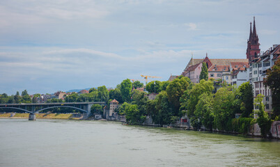 Fototapeta premium Buildings in the city centre of Basel and the Rhine river, Switzerland. Riverside of swiss city