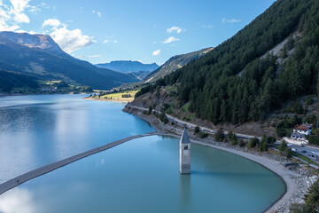 Obraz na płótnie Canvas drone flight over Lake Reschensee in South Tyrol