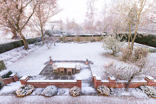 Garden in winter, snow covered backyard scene, UK