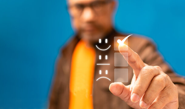 Satisfaction survey and Customer service concept, Businessman or Business people are touching a virtual screen on happy Smiley face icon symbol to give satisfaction in service. rating very impressed.