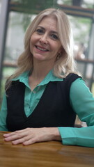 Portrait of a happy female senior executive woman. Businesswoman closeup face looking at camera in...