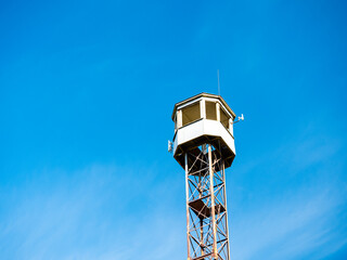 Fototapeta na wymiar Old observation tower against the sky