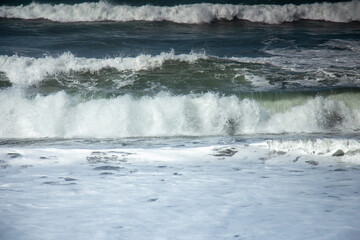 The waves approaching the shoreline