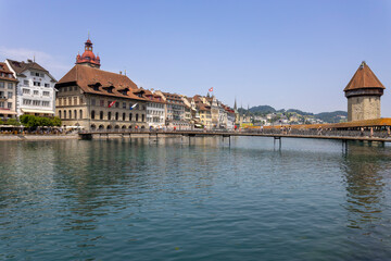 Fototapeta na wymiar LUCERNE, SWITZERLAND, JUNE 21, 2022 - View of Rathaussteg bridge and the City Hall (Rathaus) in the center city of Lucerne, Switzerland