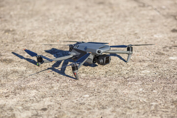 explore consumer drone with unique tele camera scout and plan shots on gray concrete background