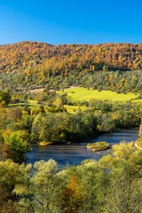 Fototapeta na wymiar The San River Valley. The village of Tworylne, Bieszczady Mountains, Poland. Colorful autumn mountain landscape.