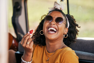 Happy, road trip and black woman eating a strawberry in a car on a travel holiday in nature....