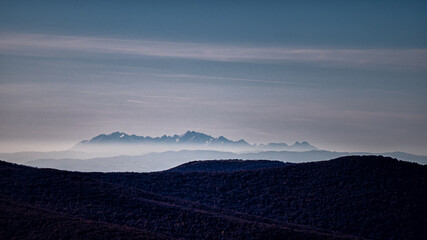 The Tatra Mountains seen from the Bieszczady Mountains. The temperature inversion and long distant visibility.