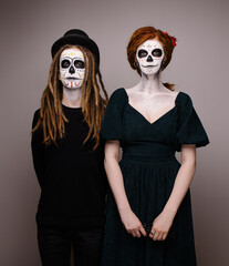 Couple costume for husband and wife mexican day of the dead. Scary skull makeup for halloween. Bride and groom dead zombie masquerade. All Saints' Day is a holiday. Scary faces. Idea for a carnival