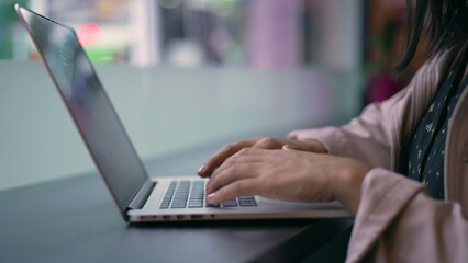 Fototapeta premium One young hispanic woman opening laptop in coffee shop remote workplace. South American Brazilian girl using computer typing in keyboard