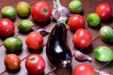 Blue eggplant fruit, red ripe and green tomatoes