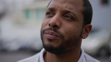 One anxious young African American man in distress closeup face. Portrait of a black person with worried preoccupied emotion