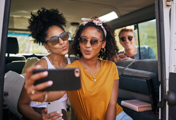 Selfie, phone and road trip with girl friends taking a photograph while sitting in a car or van on...