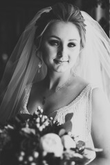 Portrait of beautiful bride with fashion veil at wedding morning