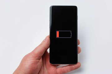 Smartphone in hand with low battery