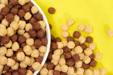 Corn balls with cocoa on a yellow background. Quick cereal healthy breakfasts for children and adults.