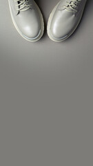 beige women's shoes on a gray background. Autumn shoes. Vertical image