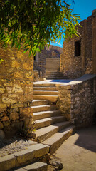Stairs of Spinalonga. View of the abandoned building and stone stairs in the old town of Spinalonga island, Greece.
