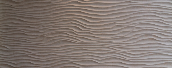 Stone waves, beautiful three-dimensional wave structure worked in beige colored stone slab. Copy space for your design or product. Web banner.