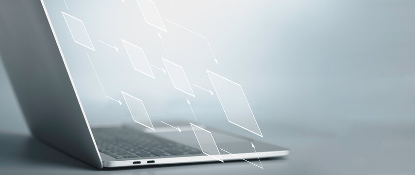 Business flowchart diagram and workflow automation in mindmap or organigram on virtual screen. A businessman is using a laptop to come up with a new project with an empty text box for your text.