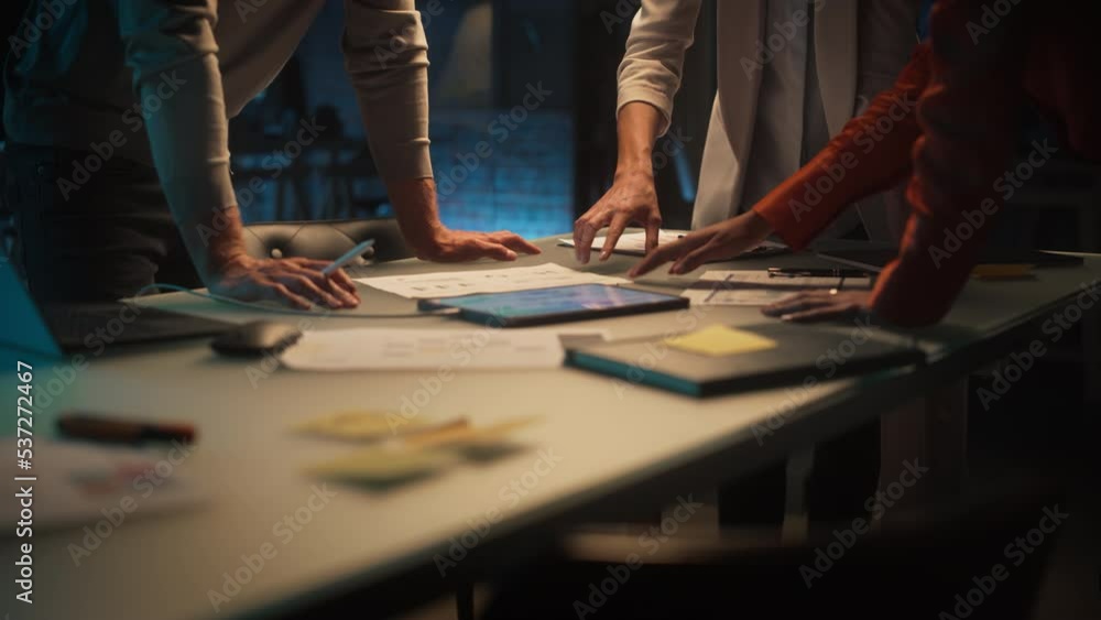 Aufkleber close up on colleagues discussing a new business opportunity, putting hands on a meeting room table 