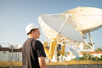 Engineer looking earth based astronomical radio telescope