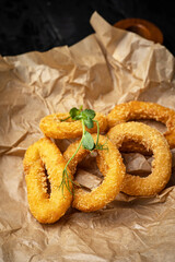 Crispy Fried Squid Rings. On a dark background
