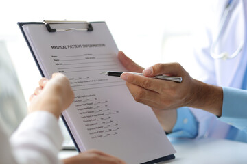 Doctor write prescription and advise patient to use medicine in hospital examination room, treatment the disease with medicine from a specialist. Concept of medical treatment and health consultation.