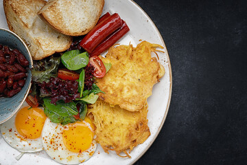English breakfast with fried sausages, beans and fried eggs