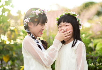 Fototapeta premium Two Asian sister in garden