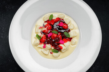 Lazy dumplings with cherries in sour cream