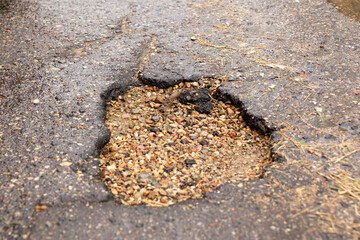 Water filled pot hole in the road.