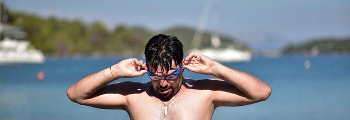 portrait of a man in swimming goggles. Adriatic sea Croatia island Mljet