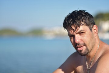 Fototapeta na wymiar portrait of a man sitting on the beach