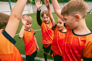 Soccer junior team with medals and trophy. Sportive boys celebrating victory. Concept of win,...