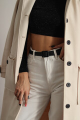 woman in coat.girl in white jeans and coat.female torso.girl in black top.white jeans and white coat.