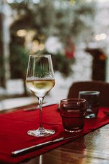Glass with white wine on the table in restaurant.