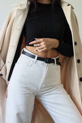 woman in coat.girl in white jeans and coat.female torso.girl in black top.white jeans and white coat.
