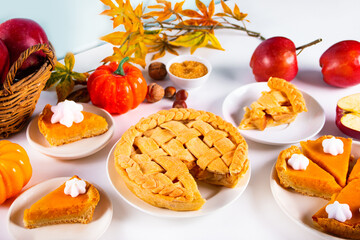 Pieces of traditional american homemade autumn apple and pumpkin pie for Thanksgiving day or Halloween