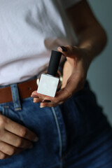 gel polish.girl holding gel polish.gel polish close up. white bottle close-up.nail polish and flowers on a white background.nail polish.female manicure.