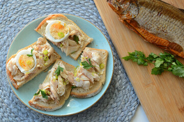 Sandwich with smoked trout and egg for breakfast