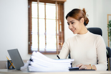 Asian women working in the office, young Asian business women as business executives, founding and running start-up executives, young female business leaders. Startup business concept.